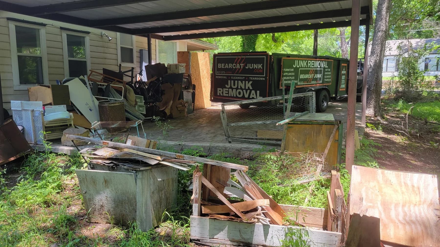 Bearcat's branded trailer beside a property cleanout